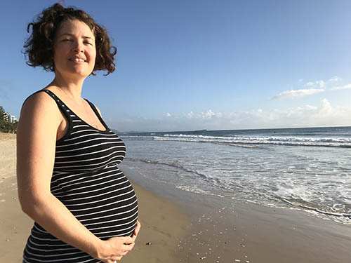 Smiling Pregnant Woman on beach in Australia