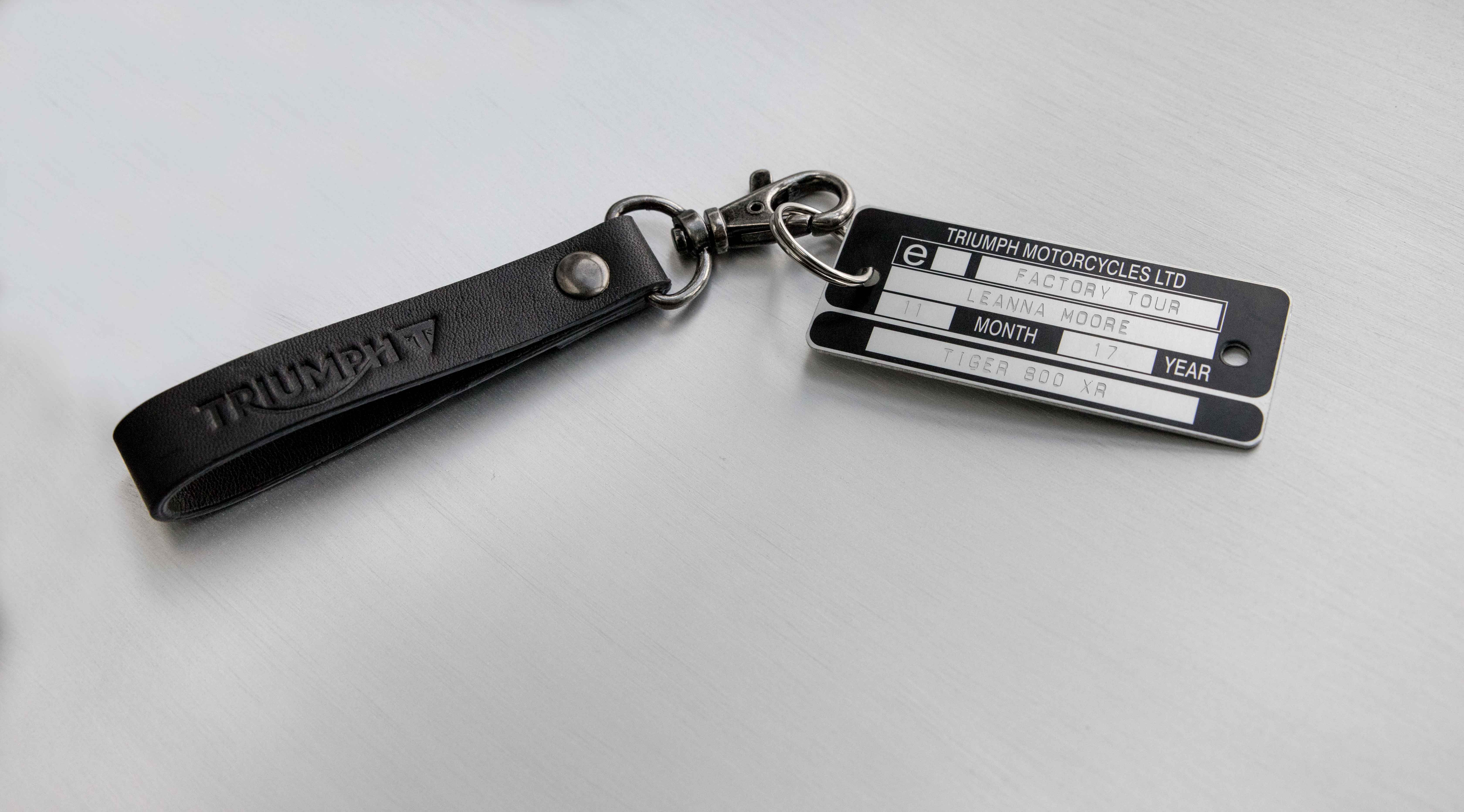 Personalised authentic Triumph VIN Plate keyring featuring an embossed black leather loop and brushed silver trigger hook