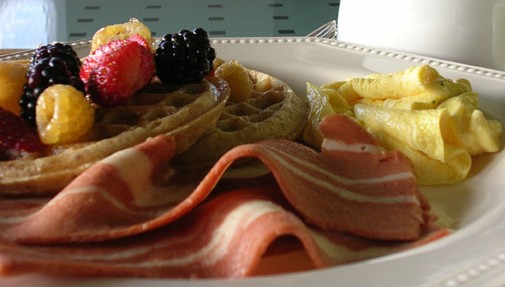 North Hollywood Organic Waffles under Organic Mixed Berries aside Vegan Eggz Omelette served with Breakfast Bakon Strips