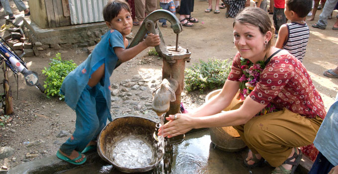 image of a woman and child in Peru with a well pump