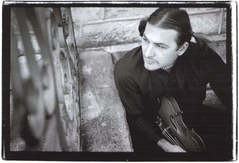 black and white portrait of musician Govinda holding a violin