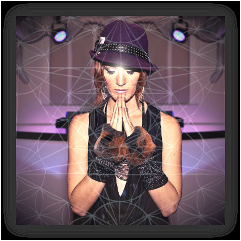 A woman in a purple studded had with her eye closed and her hands together as if praying just beneath her chin. She is wearing a tank top and arm cuffs, and the overall image is overlayed with a lattice design.