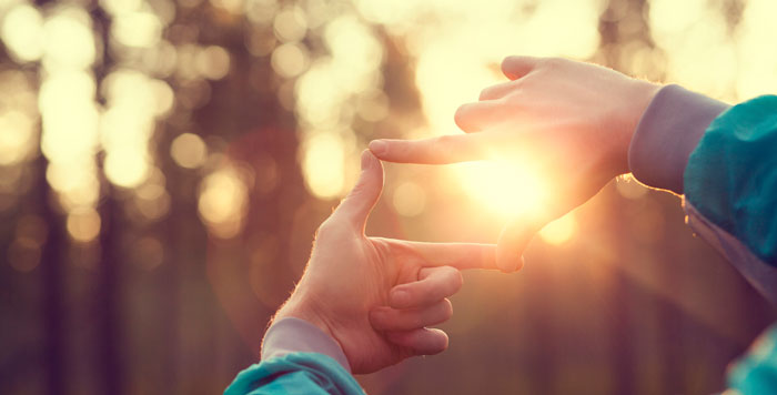 hands against the sunset