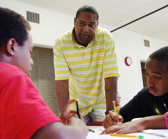 Eric is developer of Writing for the Soul Workshop. He's pictured doing what he loves: empowering youth using the art of writing.