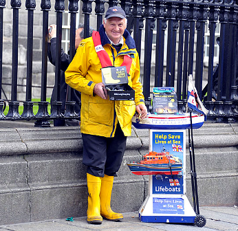 Volunteer collector selling Mayday merchandise