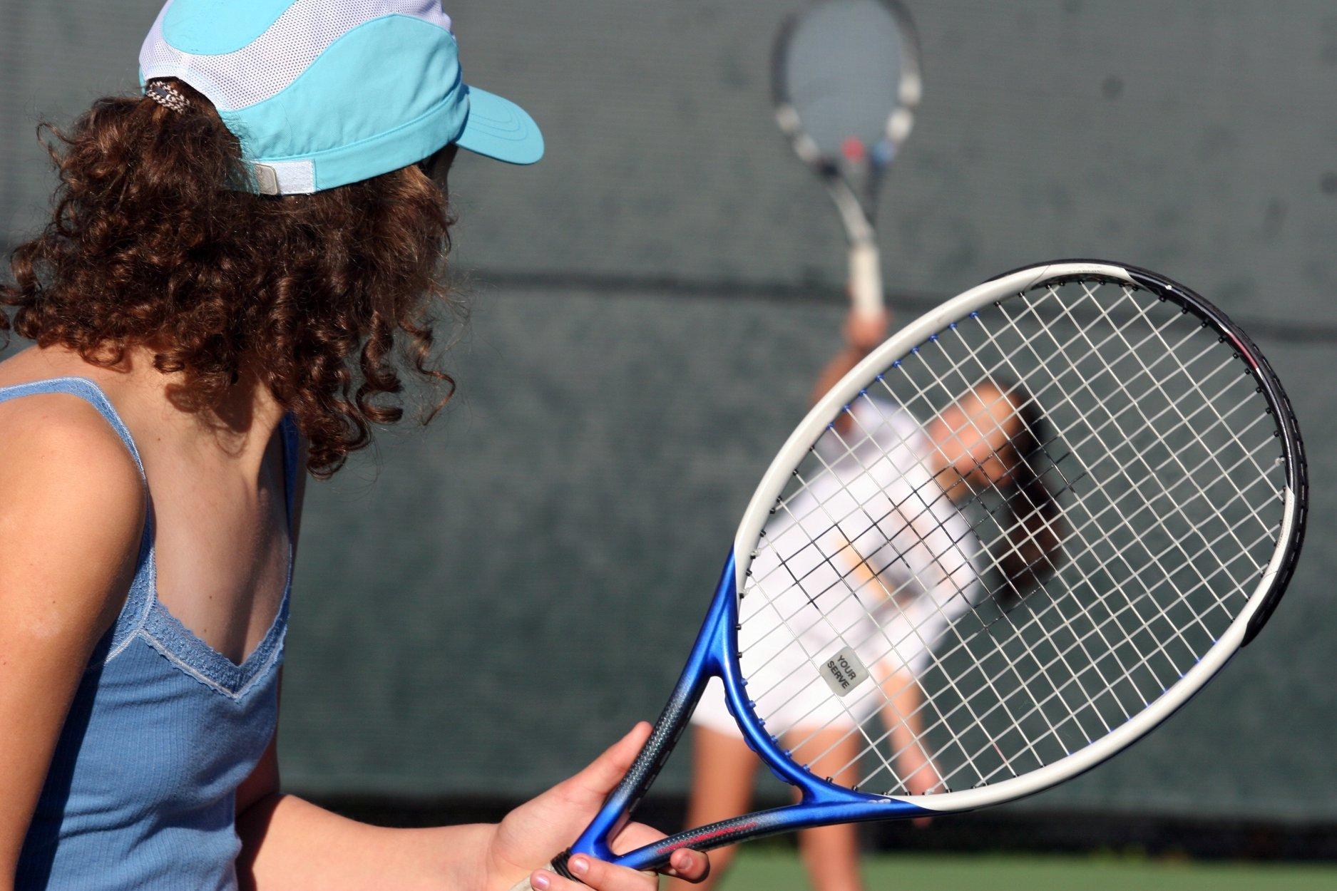 The girls play tennis. Two girls Tennis. 2 Girls playing Tennis.